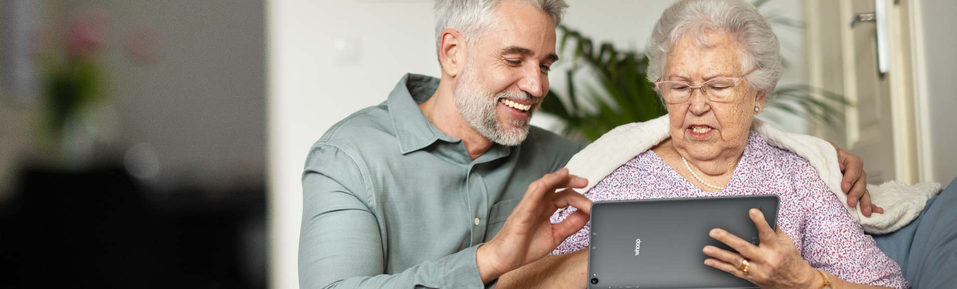 Elderly woman using a Whoop Tablet